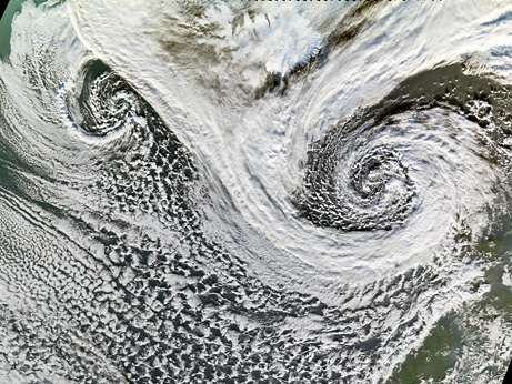 Two spiraling storms satellite view